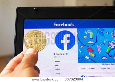 Prague, Czech Republic - June 18 2019: Golden Bitcoin Lying Homepage Of Facebook Launching Digital W