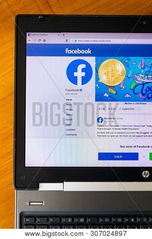 Prague, Czech Republic - June 18 2019: Golden Bitcoin Lying Homepage Of Facebook Launching Digital W