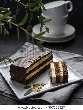 Delicious Chocolate Mozart Cake With Pistachious On Square Plate Morning Light  Window Dark Backgrou