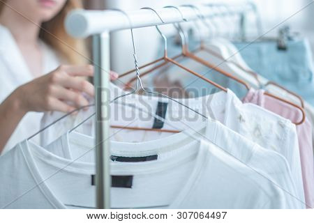 Clothing, Fashion, Style And People Concept - Woman Choosing Clothes At Home Wardrobe