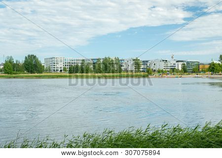 Helsinki, Finland - June 12, 2019: Toolo Bay In City Park. Across The Water Are New Residential Buil