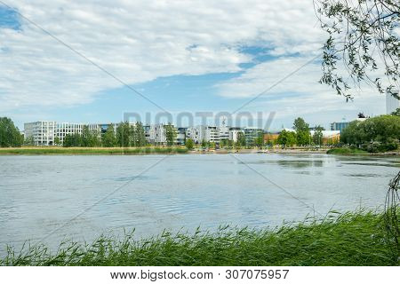 Toolo Bay In City Park, Helsinki, Finland. Across The Water Are New Residential Buildings