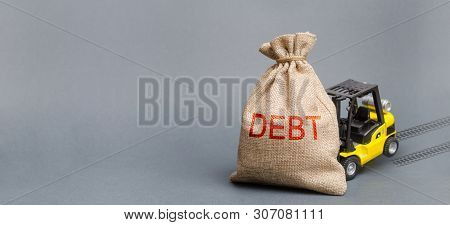 Yellow Forklift Truck Can Not Lift The Bag With The Inscription Debt. Inability To Repay A Loan, Deb