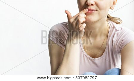 Red Bubbles Of Virus Herpes On Lips Of A Woman In Light Pink T-shirt, Lower Part Face Is Seen, Which