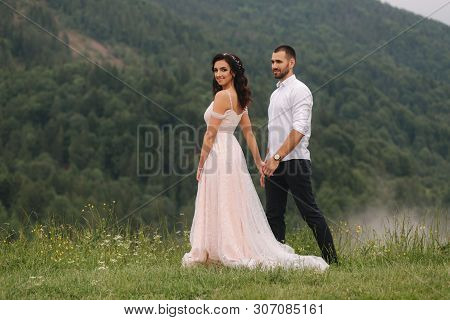 Groom And Bride Walkin Thougt The Carpatian Mountains