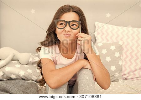 An Intellectual Look. Happy Small Girl. Small Girl Hold Fake Glasses On Face. Happy Childhood. Happy