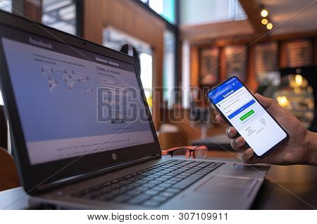 Chiang Mai, Thailand - May 01,2019: Man Holding Xiaomi Mi Mix3 With Facebook App On The Screen. Face