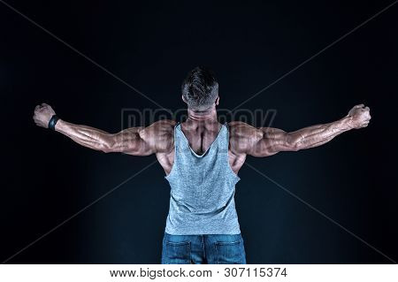 Dare To Be Great. Fit Man Back View. Fit Athlete Showing Muscular Power On Black Background. Strong 