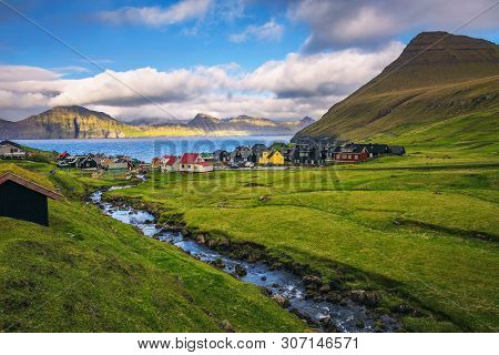 Village Of Gjogv On Faroe Islands With Colourful Houses And A Creek, With Views Of Kalsoy Island Loc