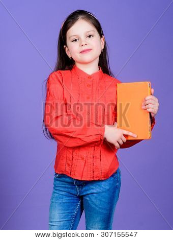 Published Information. Small Child Holding Book With Orange Cover For Vital Information. Little Girl