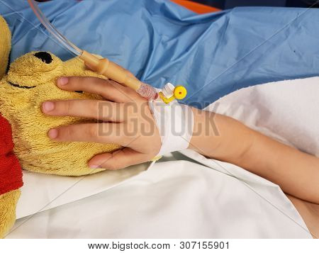 Details With The Hand Of An Ill Little Girl In A Pediatric Hospital Reserve, With A Cannula And Hold