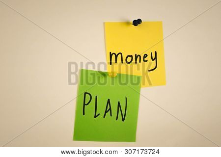 The Word Money On A Piece Of Yellow Paper Among Multicolored Paper