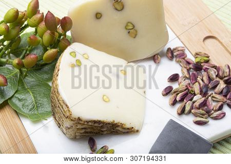 Italian Provolone Or Provola Cheese Made In Sicily With Tasty Green Bronte Pistachio Nuts Served On