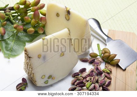 Italian Provolone Or Provola Cheese Made In Sicily With Tasty Green Bronte Pistachio Nuts Served On