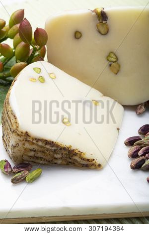 Italian Provolone Or Provola Cheese Made In Sicily With Tasty Green Bronte Pistachio Nuts Served On