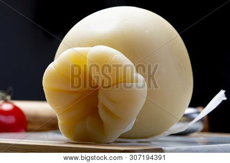Italian Provolone Or Provola Caciocavallo Hard And Smoked Cheeses In Teardrop Form Served On White M