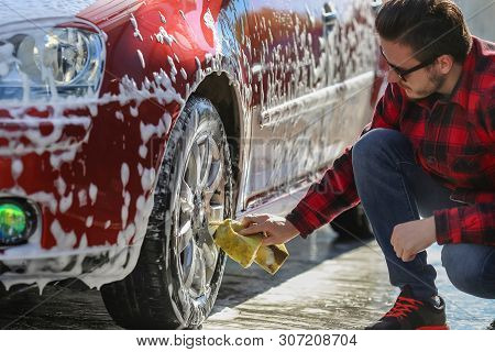 Manual Car Wash With Pressurized Water In Car Wash Outside.summe Washing. Cleaning Car Using High Pr