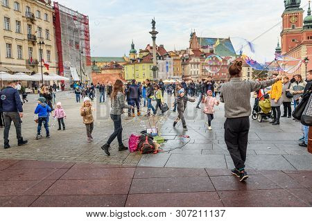 Warsaw, Poland - November 12, 2018: Women Launch Soap Bubbles On Castle Square In Old Town