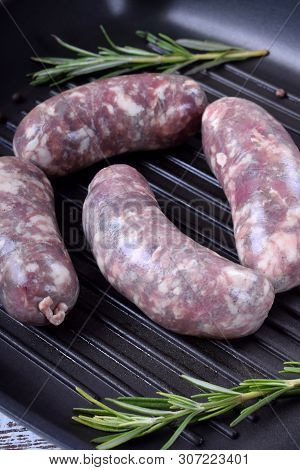 Raw Meat Sausages In A Natural Shell In A Griddle Pan Prepared For Cooking