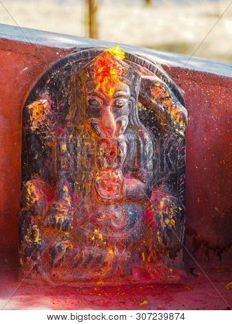 Ganesha Hindu deities shrine with vermillion red pigment powder at Kali Temple, in Dhulikhel, Nepal
