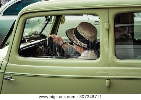 Driver Sitting And Stering In A Old Car