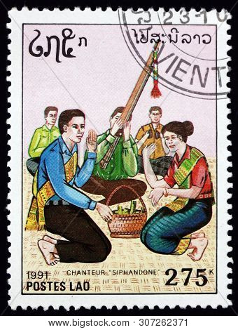 Laos - Circa 1991: A Stamp Printed In Laos Shows Man And Woman Singing Siphandone, Circa 1991