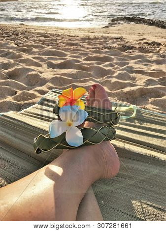 Female Feet On The Sand Sith A Hawaiian, Flower Band