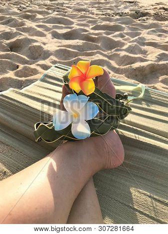 Female Feet On The Sand Sith A Hawaiian, Flower Band