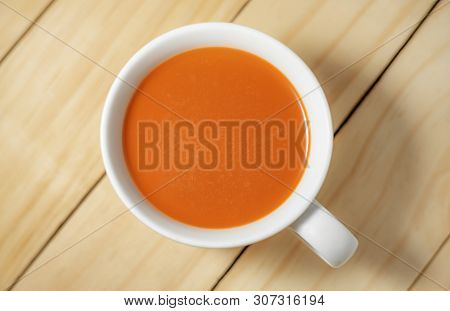 Hot Milk Tea In A White Cup On Wooden Background