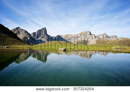 Peaks reflected in Ansabere Lake. Lescun Cirque. Aspe Valley, Pyrenees, France.