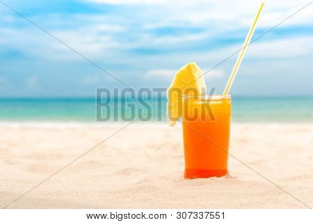 Refreshing Cold Tropical Fruit Punch Drink Garnished With Pieapple In Summer White Sand Beach Backgr