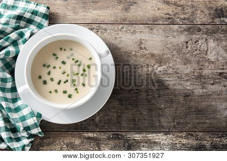French Vichyssoise Soup In Bowl On Wooden Table. Top View.copyspace