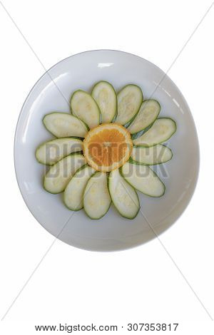 Slices Of Orange And Zucchini In The Shape Of A Flower On Oval Dish Isolated On White Background. Ch