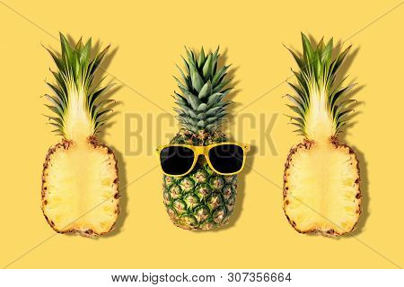Fresh Pineapples With Sunglasses On Yellow Background. Creative Suumer Concept.
