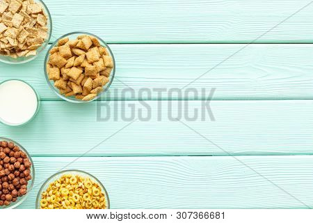 Cereals, Oatflakes And Cornflakes With Milk For Healthy Breakfast On Mint Wooden Background Top View