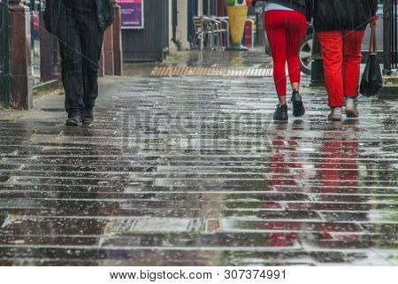 London, Uk - Jun 5, 2019 :  Pedestrian Feet Walking In The Rain In Chiswick Street.
