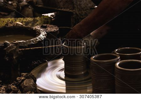 Close Up Hand Of Potter Do A Clay Vase Thai Style On A Potter's Wheel In Pottery Villages At Ko Kret