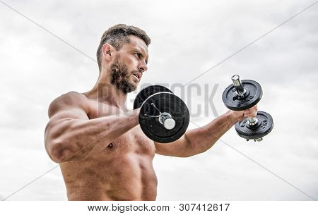 Training To Be The Best. Success. Perfect Biceps. Fitness And Sport Equipment. Man Sportsman With St