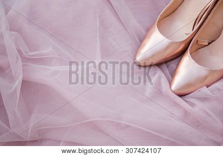 Pink Gold Bridal Shoes. Tender Beige Fatin Cloth Texture Background. Top View Of Ladys Pumps. Space 
