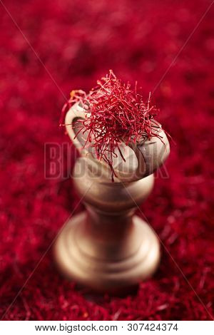 saffron threads background with iron 1lb weight, truly color, huge amount of spice , soft focus