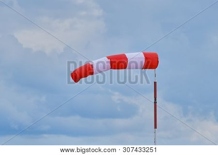 Windsock During A Strong Wind. Windsock Shows Wind Direction And Strength. Made Of Fabric In The For