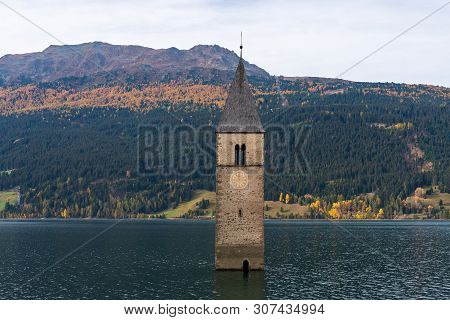 The Famous Bell Tower In The Lake Of Reschen - Lago Di Resia In South Tyrol, Italy. During Ww2 A Dam