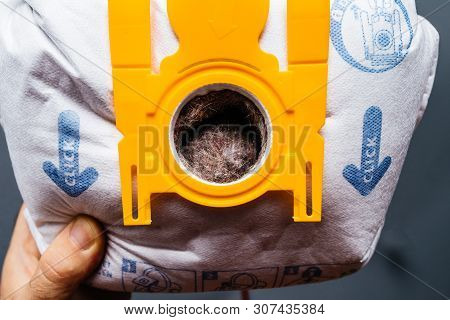 Paris, France - May 16, 2019: Close-up View Of Man Hand Holding Against Gray Background Used Swirl V