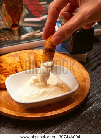 Dipping Traditional Caucasian Dushbere, Gurze Into Yogurt Sauce, Image