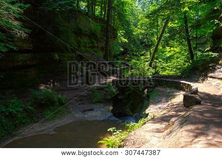 Devils Bath Tub In Hocking Hills, Ohio Surrounded By A Lush Landscape