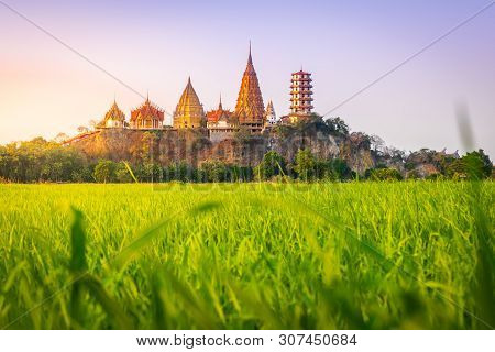 Landscape Of Wat Tham Sua Temple (tiger Cave Temple) In Sunset Scence With Jasmine Rice Fields At Ka