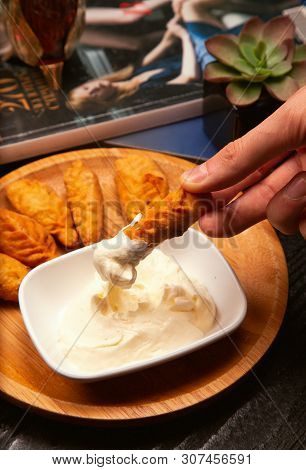 Dipping Traditional Caucasian Dushbere, Gurze Served With Yogurt On Wooden Plate To Yogurt Sauce. Im