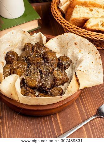 Green Grape Leaves Stuffed With Meat, Rice, Herbs, Onion And Cooked In Olive Oil, Served With Lavash
