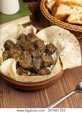 Green Grape Leaves Stuffed With Meat, Rice, Herbs, Onion And Cooked In Olive Oil, Served With Lavash