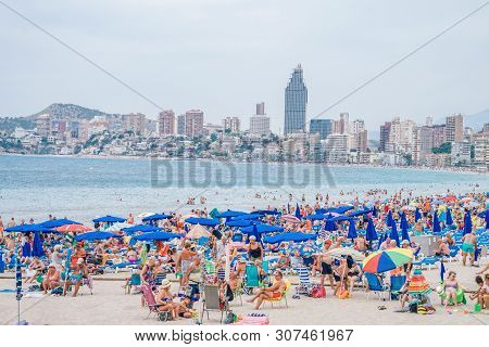 Benidorm, Spain, 16 June, 2019: View Of Benidorm Poniente Beach Full Of Resting People In Benidorm, 